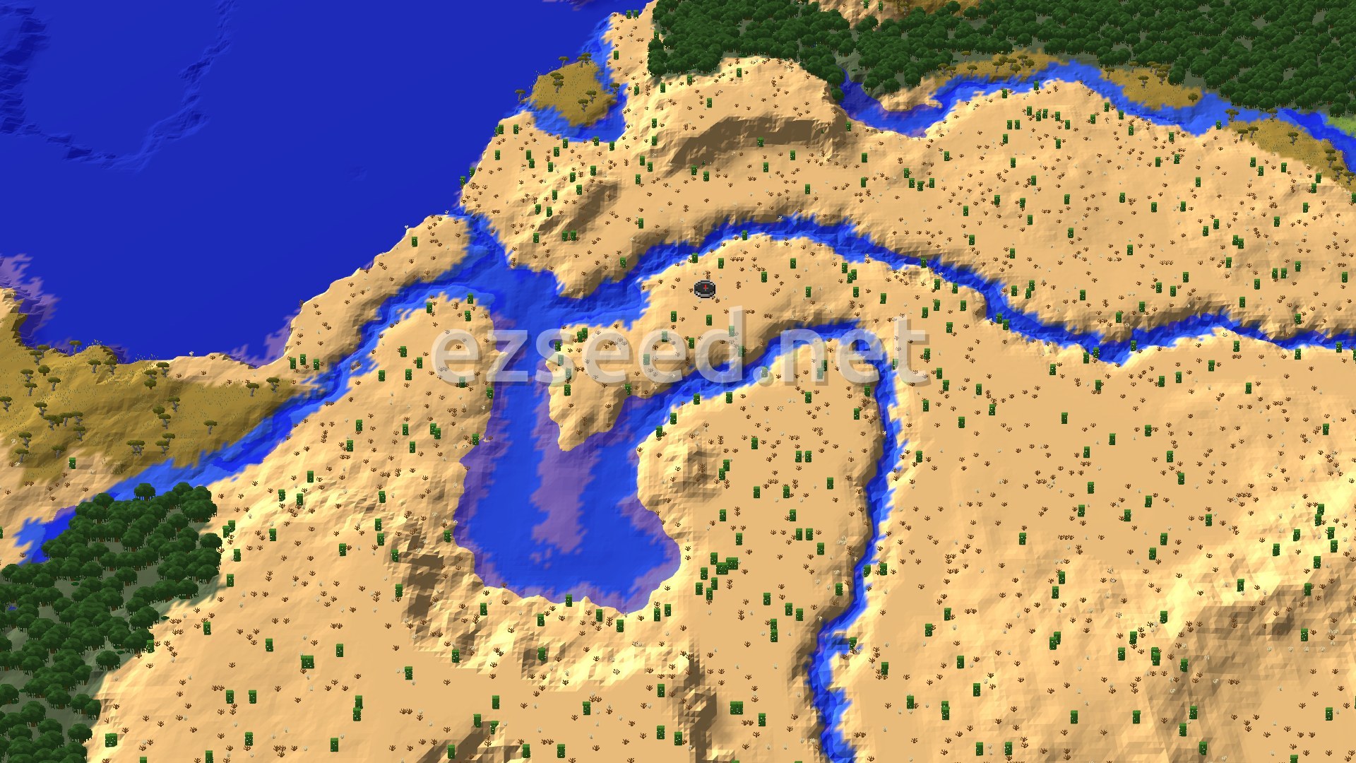 An overhead view of a mostly desert landscape, featuring a large body of blue water to the west and north, with rivers snaking through the sand. Scattered green trees and cacti are visible across the sandy terrain, and a small spawn marker is in the center.