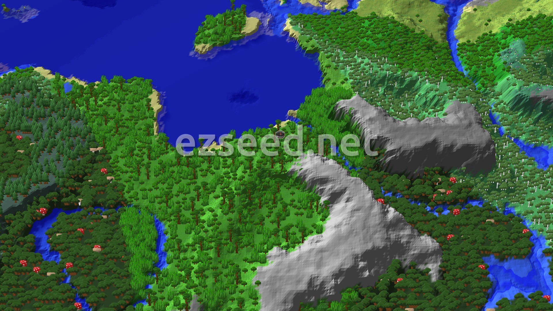 An aerial view of a dense green jungle biome with a winding blue river, bordered by a large blue ocean and grey, windswept mountains. A small spawn marker is visible in the jungle.